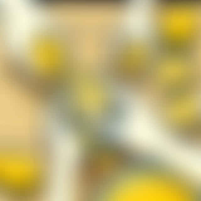 juicing lemons into a bowl